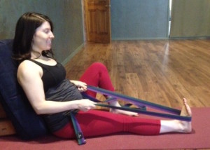 Modification using bolster. Since lying on the back is counter-indicated during pregnancy, Jen happily practices pictured modification.