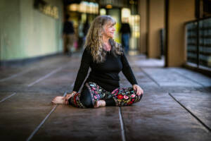 Woman sitting in thoughtful yoga pose